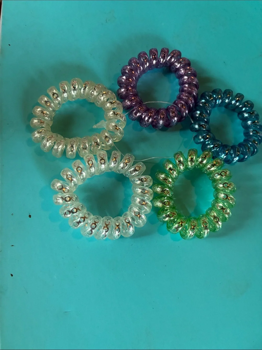 Set of 5 Coiled Hair Ties in Clear, Purple, Blue, Green